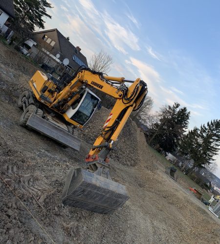 a house with a garden and cars parked in the street